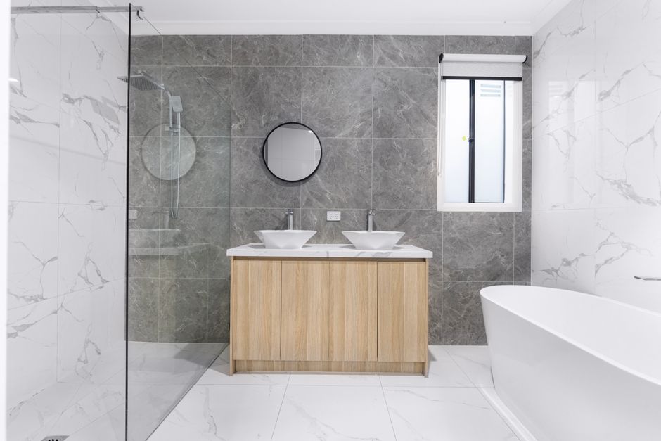 Elegant bathroom renovation featuring premium tile and fixtures